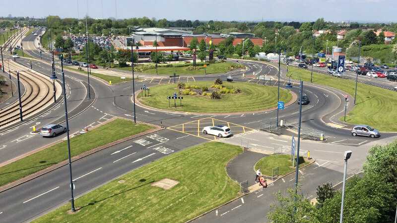 A complex roundabout with traffic on.