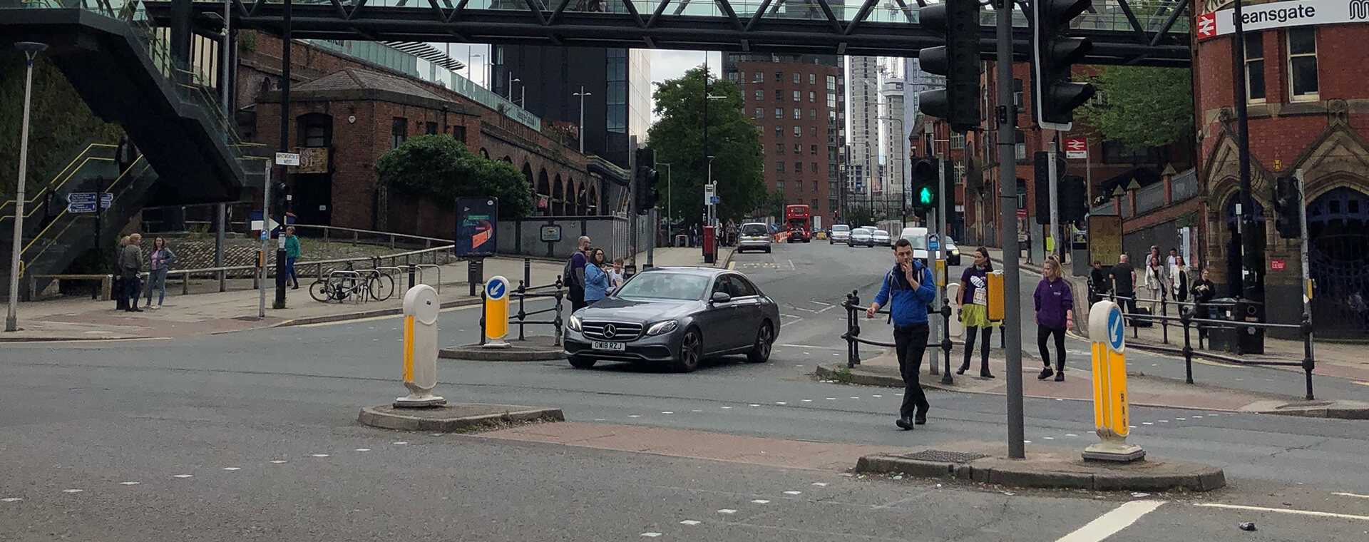 People crossing the road via traffic lights